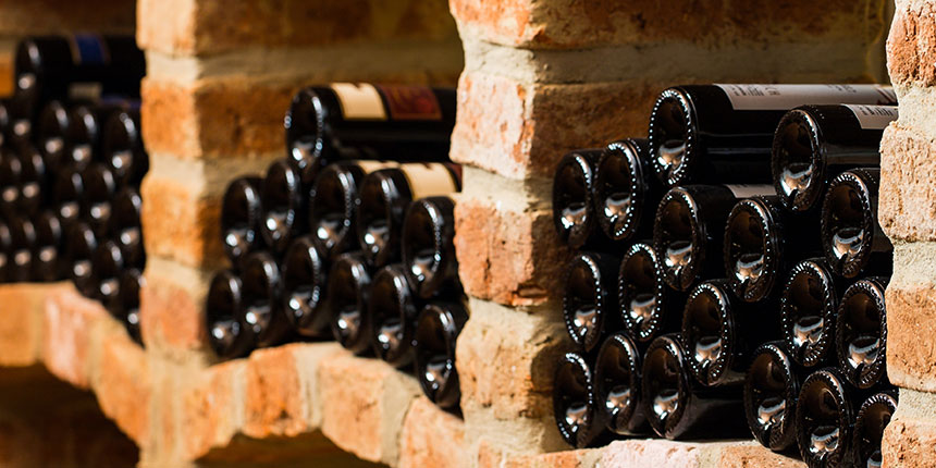 Wine bottles stacked in a wine cellar